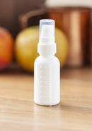 1 oz / 30 ml White Graduated Plastic HDPE Boston Round Bottles with White Treatment Pump (12) JUVITUS