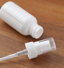 1 oz / 30 ml White Graduated Plastic HDPE Boston Round Bottles with White Treatment Pump (12) JUVITUS